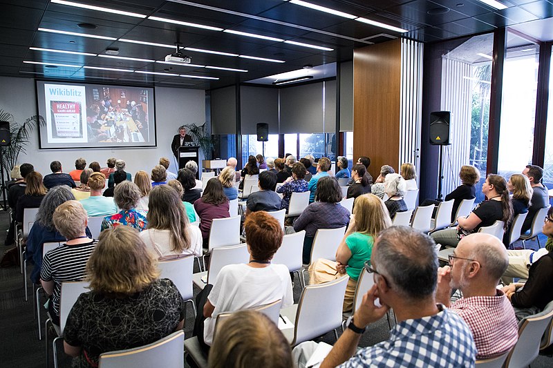 Audience watches a presentation.