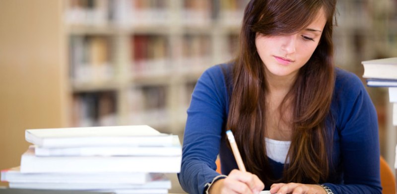 Woman writing in notebook.