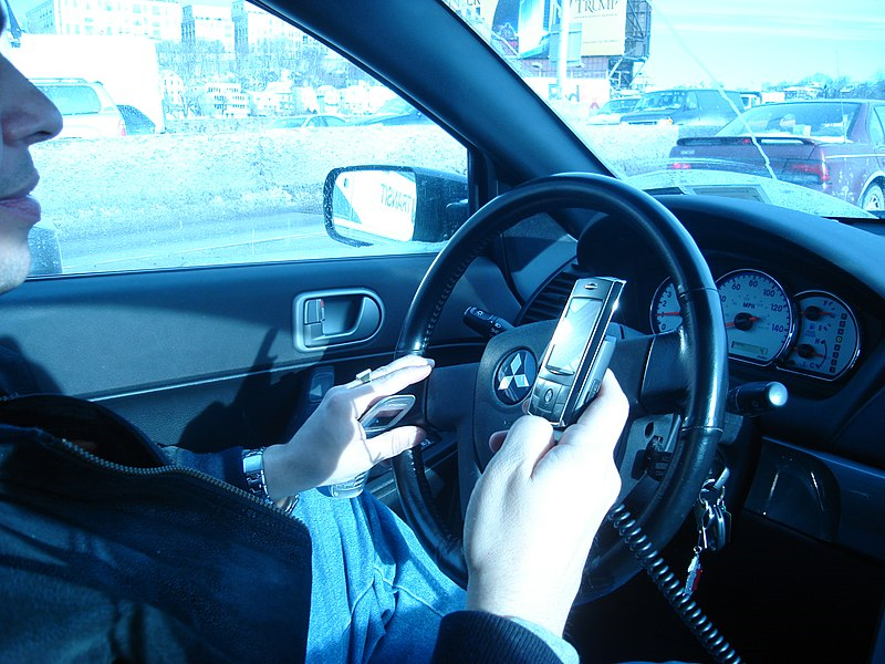 Man drives while texting.