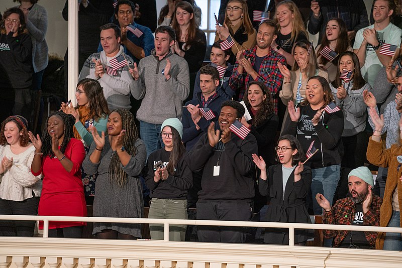 Photograph of audience applauding.