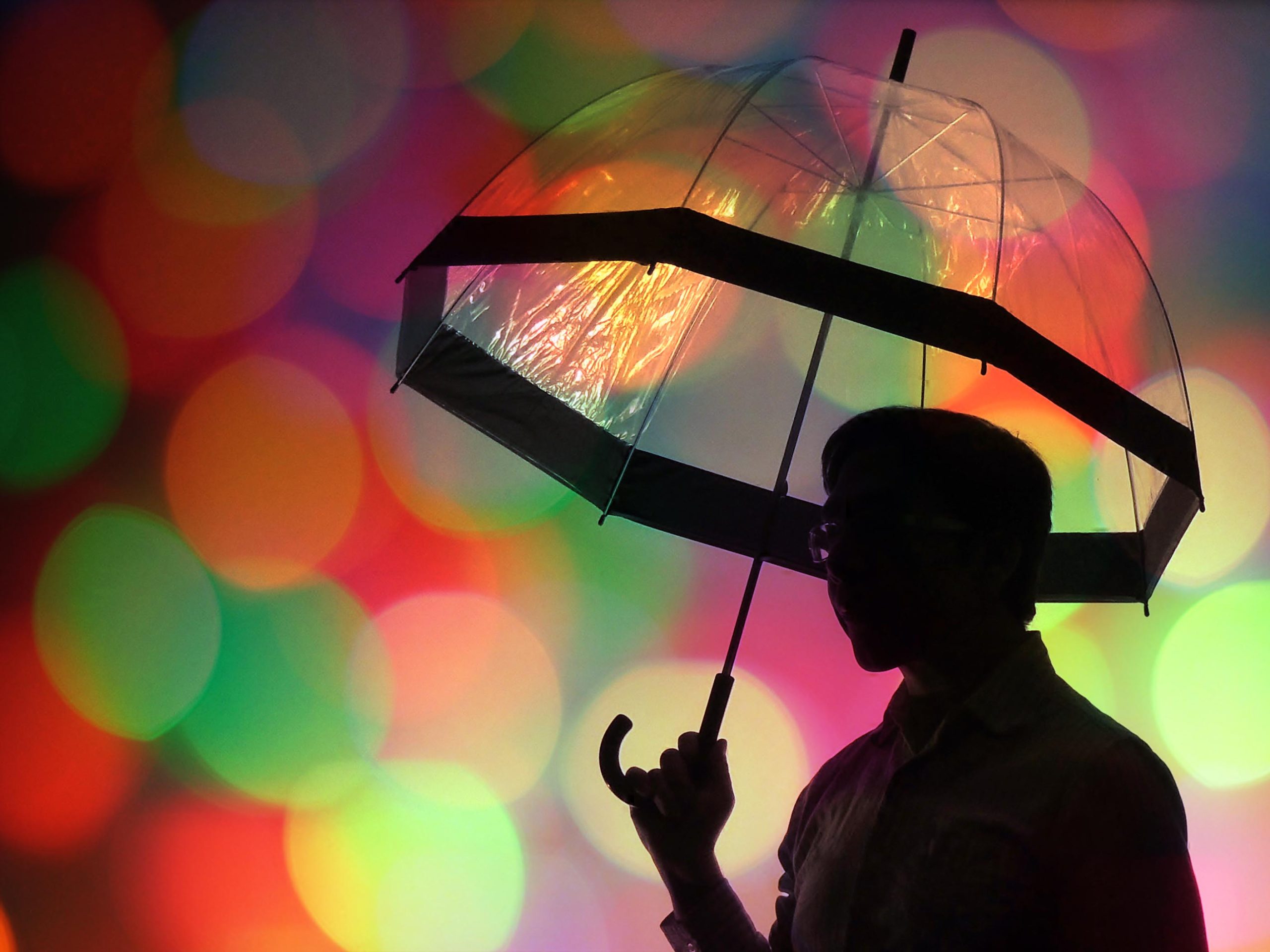 Bokeh Silhouette image of a person in front of Christmas lights