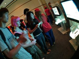 A group of teens play a video game.