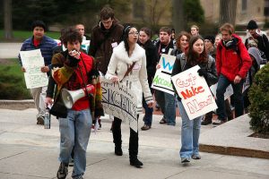 A number of people march in protest of Nike.