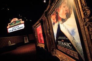 Titanic film poster in movie theatre lobby.