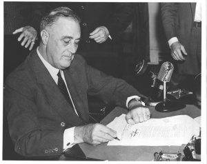 FDR signs legislation.