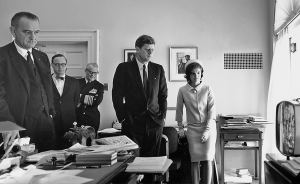 Photo of JFK, his wife, and Lyndon Johnson watching television.