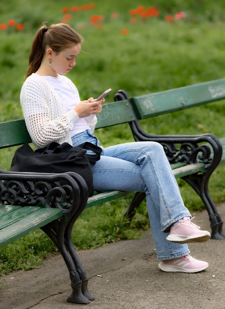 Teenager uses a cellphone.